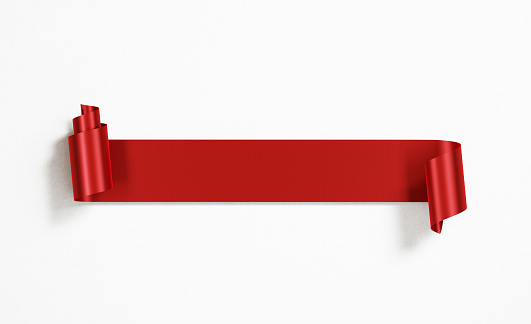 Red ribbon banner on white background Horizontal composition with copy space.