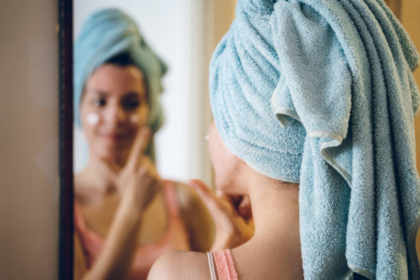 istock Beauty applying moisturizer on her Face 1157569046
