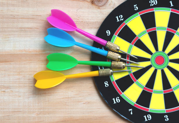 istock Darts and dart board on the wooden table 1157569908
