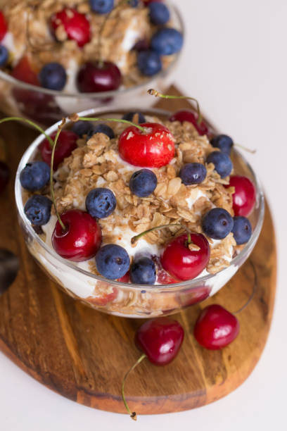 Food. Fruit salad with cherries, blueberry, muesli, yogurt