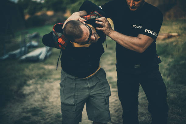 Pointing to the criminal a police officer drove a drug dealer to the police station drug addiction tattoos stock pictures, royalty-free photos & images