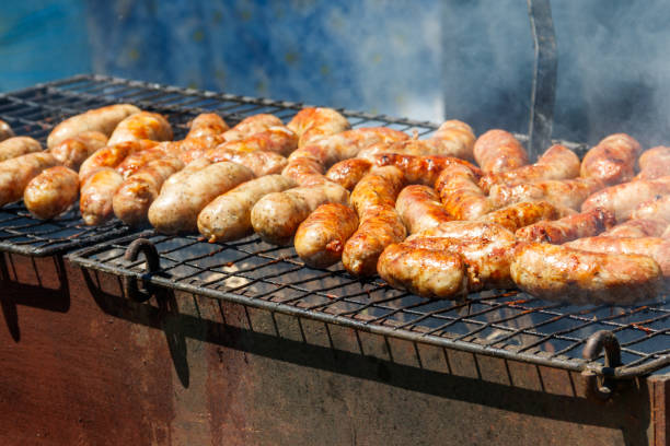 istock Sausages cooking on a grill 1157581941