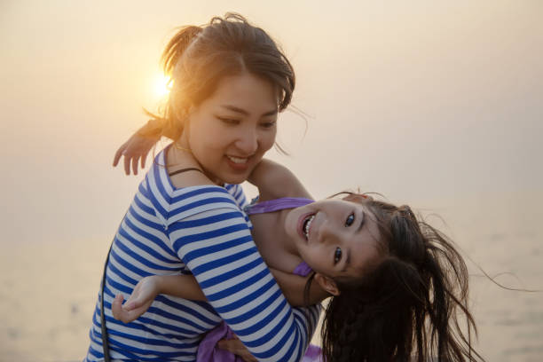 istock beautiful moment with mom and kid play and hug 1157584375