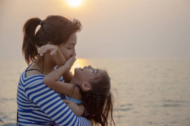 istock beautiful moment with mom and kid play and hug 1157584378