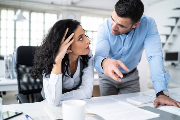 coworkers sitting at workplace and discussing problems - irritants imagens e fotografias de stock