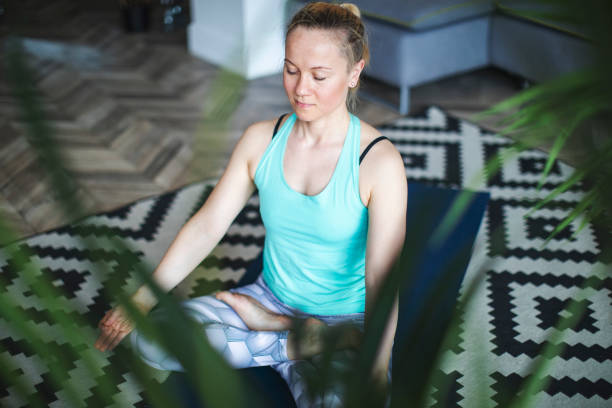 istock Woman practicing yoga at home 1157584678