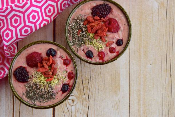 istock Smoothie bowl with berries, hemp seed, chia seed and cacao nibs 1157585573
