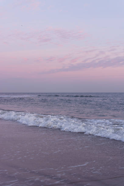 istock Calm waves rolling into the shore at the beach during sunset 1157585999