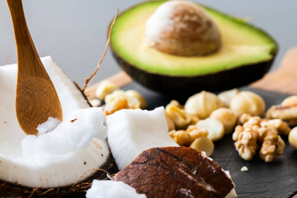 A close up of healthy ketogenic food A close up of ketogenic food: coconut and coconut butter, avocado. walnuts and macadamia nuts low quality of life stock pictures, royalty-free photos & images