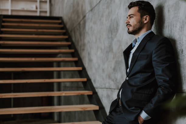 istock Serious man in classic suit at stairwell 1157590849