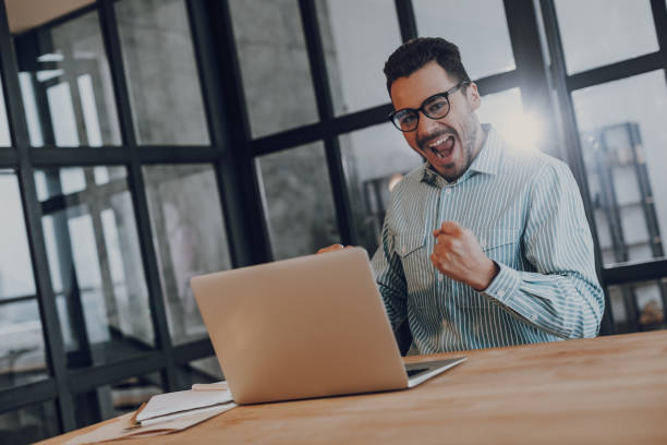 istock Excited man succeed in working on laptop 1157590921