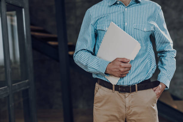 istock Stylish man is carrying folder to office 1157590925