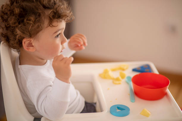 istock Baby boy eating on his own 1157590972