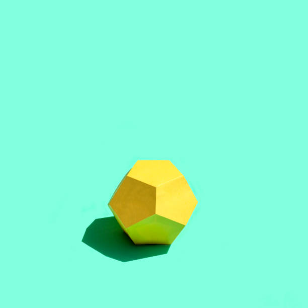 istock Paper yellow dodecahedron in bright sunshine 1157592433