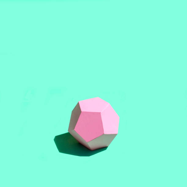 istock Paper pink dodecahedron in bright sunshine 1157592434