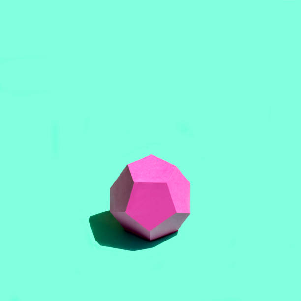 istock Paper pink dodecahedron in bright sunshine 1157592437