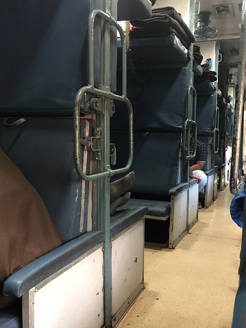 Stock photo showing the  interior view of an Indian long distance railway sleeper carriage travelling to Goa, India.