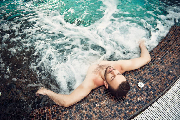 istock Bearded man with closed eyes having rest in the swimming pool 1157598436