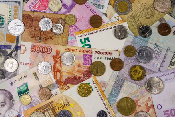 istock Background of banknotes and coins from different countries 1157601128
