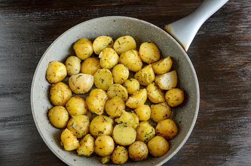 Roasted young potatoes in a pan.