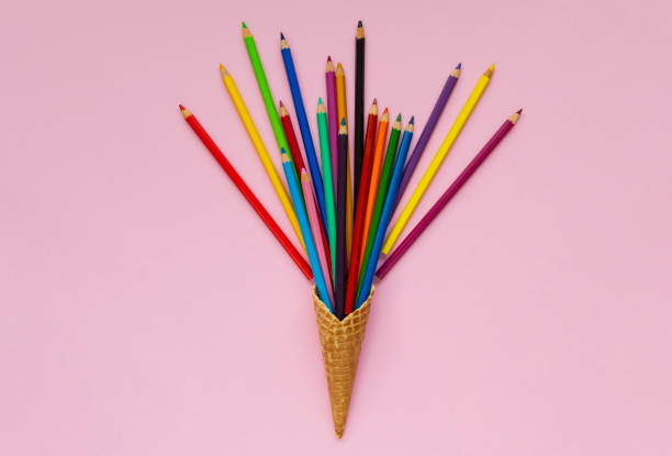 Colored pencils in water with drops on a bokeh background. Background blurred multicolored pencils