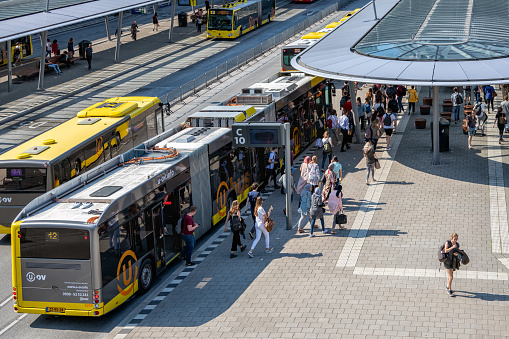 Utrecht, The Netherlands - May 15, 2018: Articulated city buses arriving and leaving at bus station near main railway station Utrecht