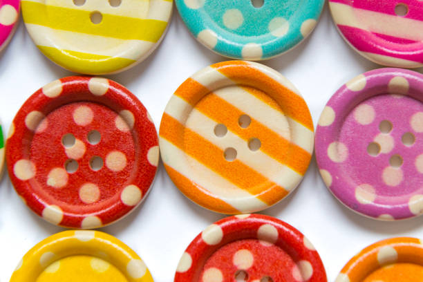 istock Full frame photo of various colorful sewing buttons on white background. High angle view 1157602854