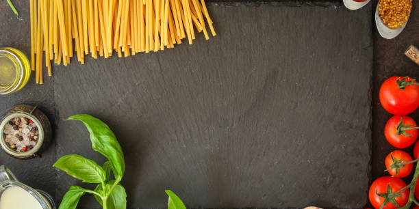 pasta, spaghetti or bucatini and tomato sauce ingredients. food background. copy space