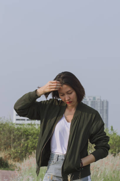 istock Woman standing in the grass field 1157612742