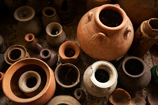 Top view shot of a group of ancient pottery vessel are display at the local museum of Sing Buri, Thailand. The museum is open to the public.