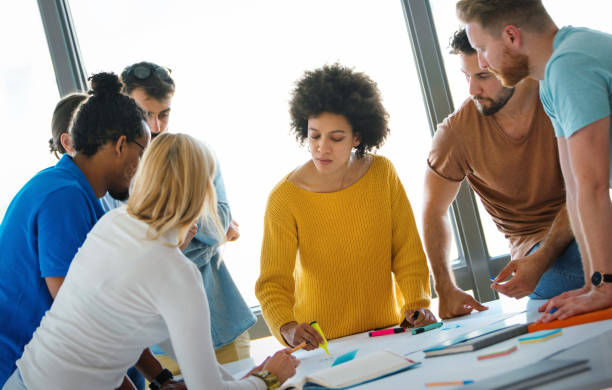 istock Group of young designers at a studio. 1157613080