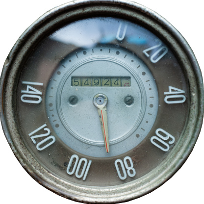 old retro speedometer from car, vintage mechanical speedometer on white isolated background close-up