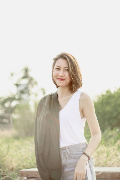 istock Woman standing in the grass field 1157615362
