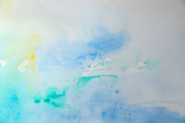 Abstract wet blue watercolor background on white watercolor paper. My own work.