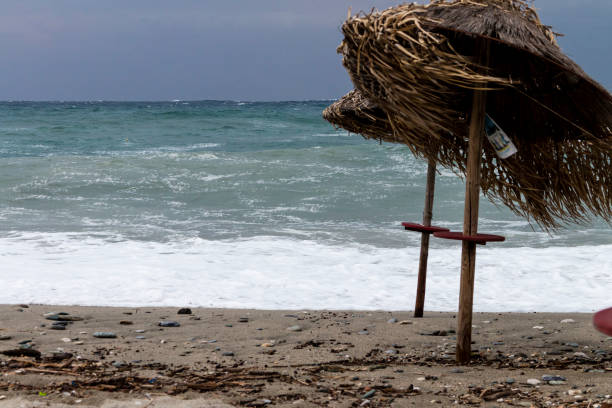 Storm at the beach is destroying parasols