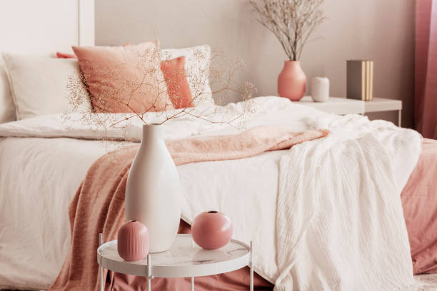 istock Different types of vases on small coffee table in bright bedroom interior 1157619408