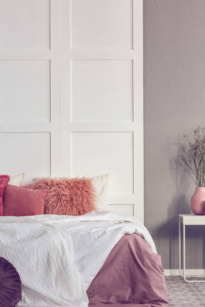 istock Vertical view of contemporary bedroom interior with white and grey wall 1157619413
