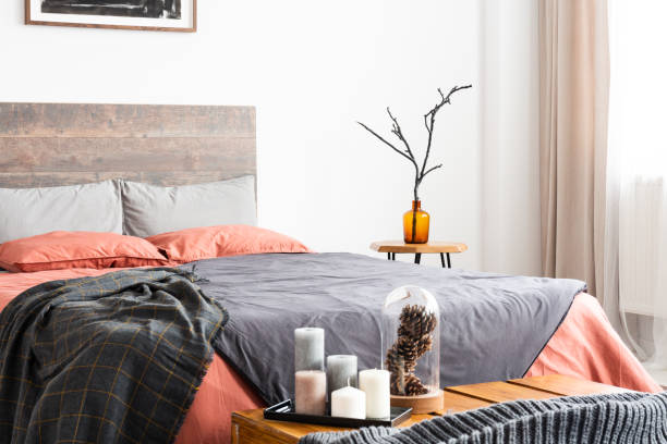 istock Candles and natural decorations standing next to wooden bed 1157620735