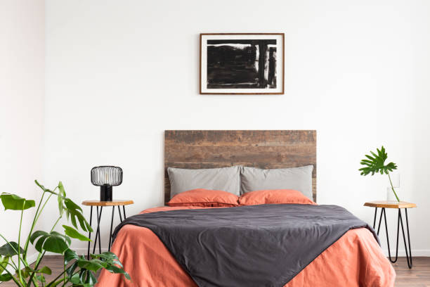 istock Bright natural interior with wooden bed and coral linen sheets 1157620738