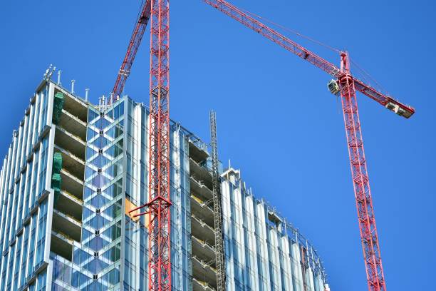 istock Skyscraper building during construction. Crane attached to building. 1157620777