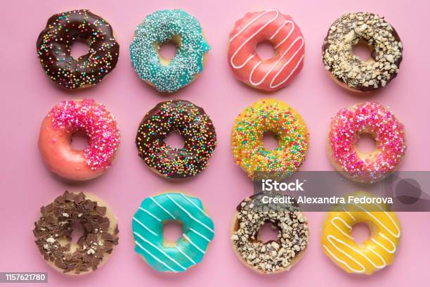 Colorful Sweet Background Delicious Glazed Donuts On Pink Background Stock Photo - Download Image Now