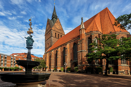 Bruges, Belgium - June 28, 2023: The historic town square Markt in the heart of Bruges city center. The city's most famous monuments is the 12th-century bell tower with restaurants, cafes and shops against the medieval buildings.