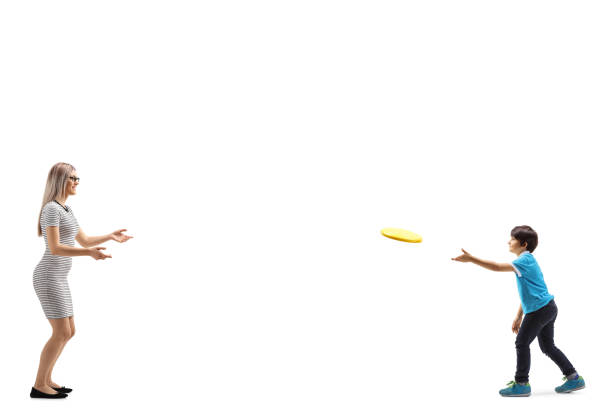 istock Young woman and a boy playing with a frisbee 1157629794