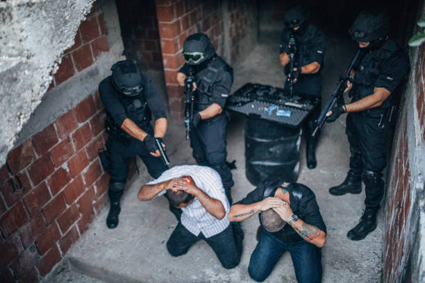 istock Police Arresting Gangster In Warehouse 1157631432