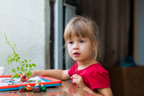 istock Little cute girl playing table play outside 1157631463