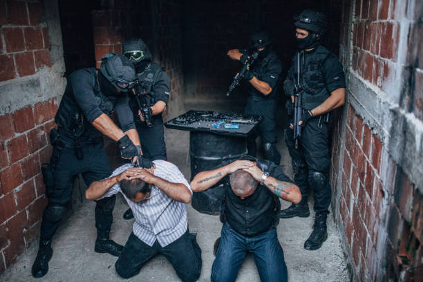 istock Police Arresting Gangster In Warehouse 1157631659