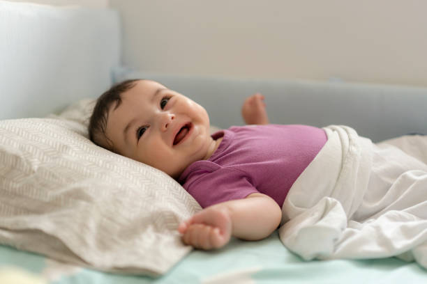 istock Cute baby boy lying in bed 1157632958