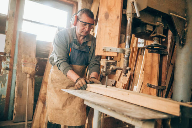 istock Carpenter cutting wooden plank 1157633026