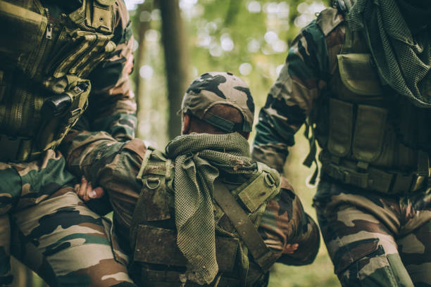 istock Soldiers Carrying Injured Man 1157633883