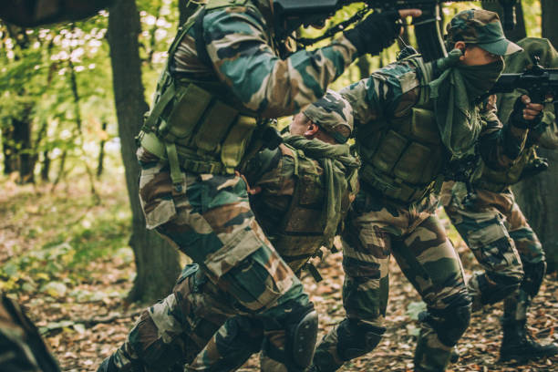 istock Soldiers Carrying Injured Man 1157633928